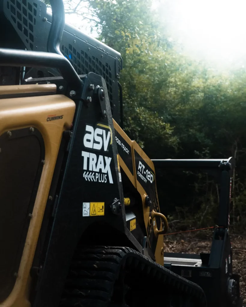 Side of the ASV RT-120 cab in the woods