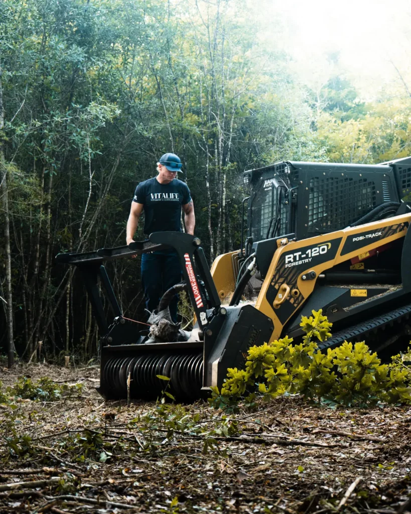 John Williams standing on the tracks of his ASV RT-120 forestry mulcher